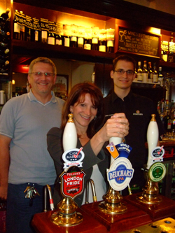 Lynne Featherstone behind the bar at the Three Compasses