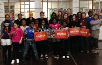 Lynne Featherstone MP with school children and hunger banquet attendees with the ‘enough food for everyone’ campaign briefcase. 