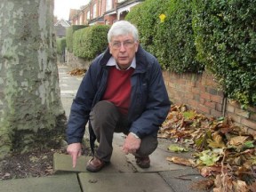 Cllr Jim Jenks on Priory Avenue, N8,  inspecting one of the many broken and uneven pavements in Haringey