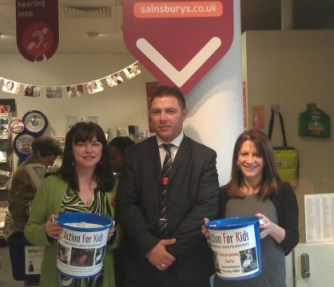 PR Ambassador Catherine Ling, Store Manager Richard Bannister, and Lynne Featherstone MP with charity collection buckets, at the front of the Sainsbury’s Muswell Hill store