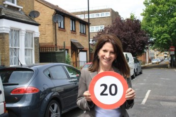 Lynne Featherstone MP with a 20mph sign on a street in Hornsey