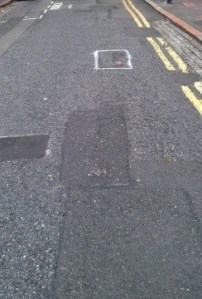 Lightfoot Road in Hornsey, where a man suffered brain injury as a result of tripping in a pothole. Some potholes have been filled but others (which had been marked for repair) were left untouched.